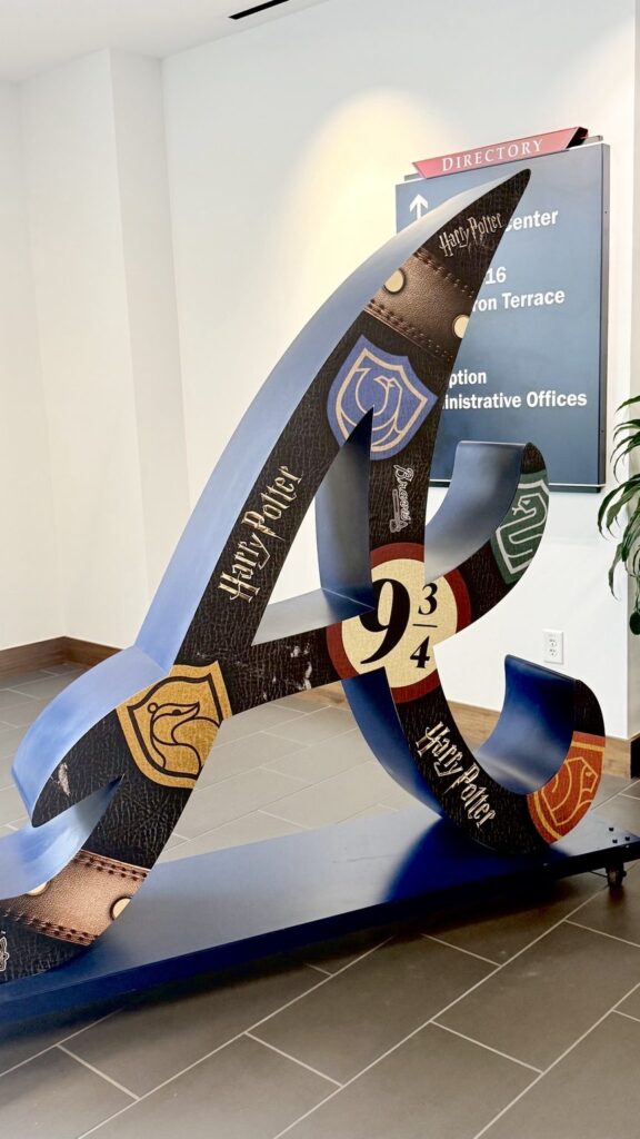 Braves sculpture wrap with Hogwarts-inspired designs and a Platform 9 3/4 reference at Truist Park
