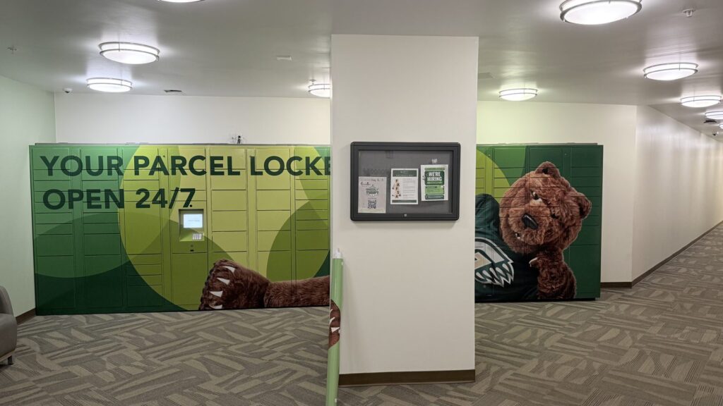 Locker wrap installation across two Amazon parcel locker banks on either side of a hallway column at Georgia Gwinnett College.