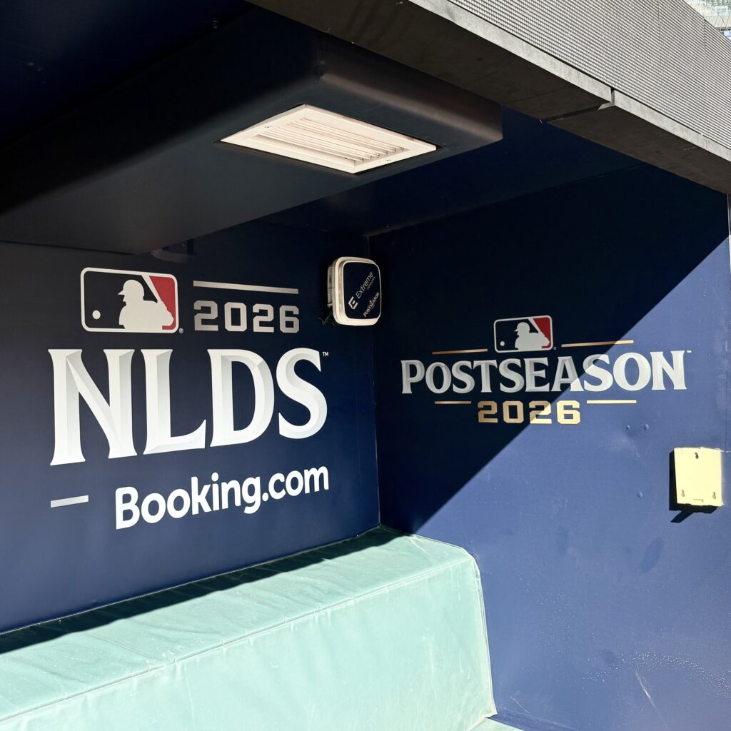 Custom 2026 NLDS postseason dugout graphics installed by Black Diamond Designs at Truist Park in Atlanta.
