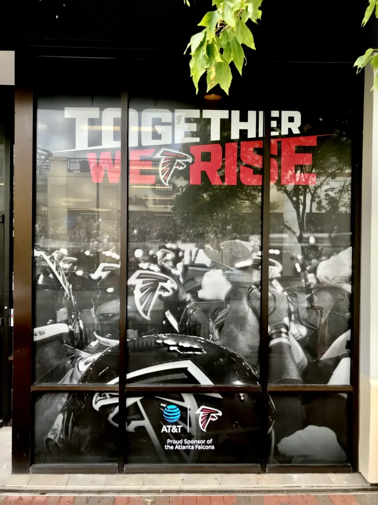Close view of Atlanta Falcons and AT&T Together We Rise window graphics printed and installed by Black Diamond Designs.