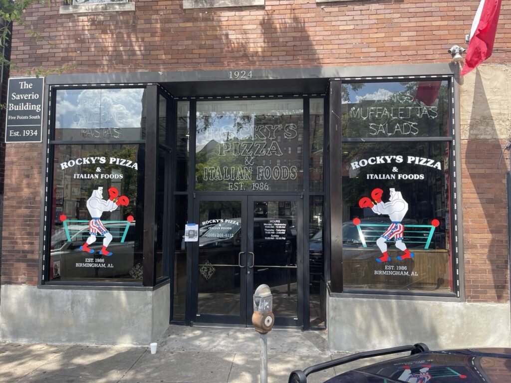 Restaurant window graphics: full façade of Rocky’s Pizza and Italian Foods at The Saverio Building in Birmingham with matching boxer illustrations in its two front windows.