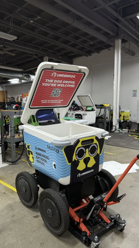 Fleet of UNDERDOG delivery robots with custom vinyl wraps in the Black Diamond Designs shop.